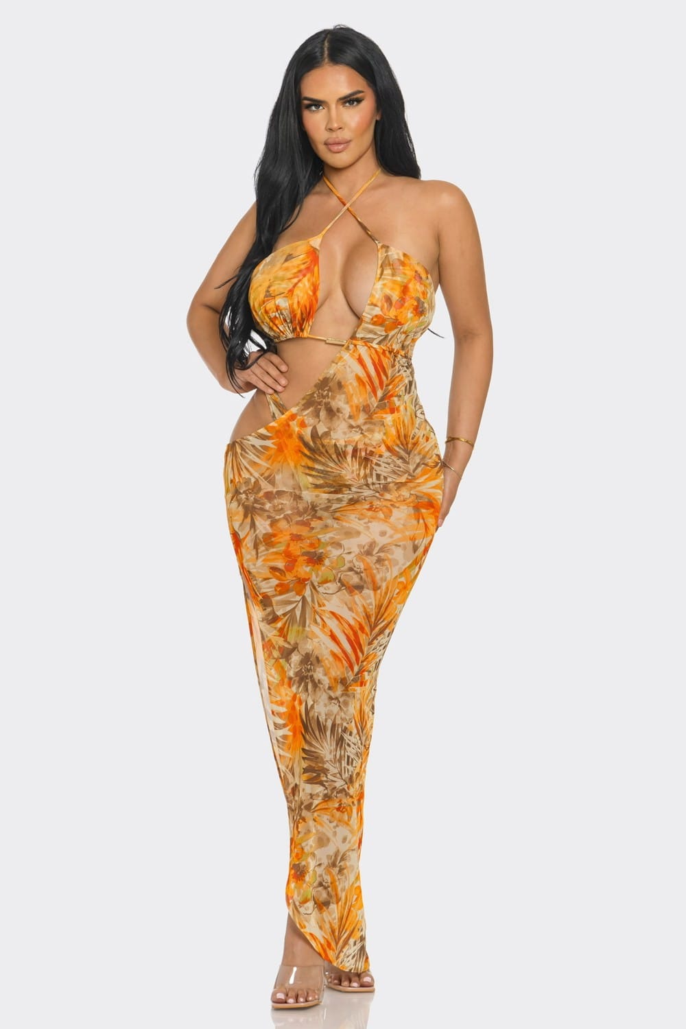 Woman wearing a floral dress with cut-out design on a white background