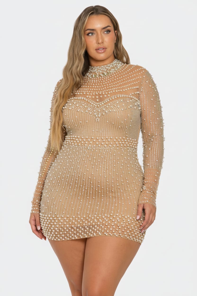 A woman modeling a sheer beige mini dress covered in small pearl-like beads, featuring a high mock neck and long sleeves, against a light gray studio background.