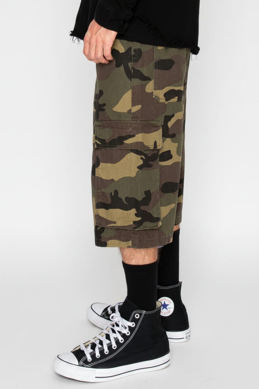 Camouflage shorts worn by a person with black high-top sneakers on a white background
