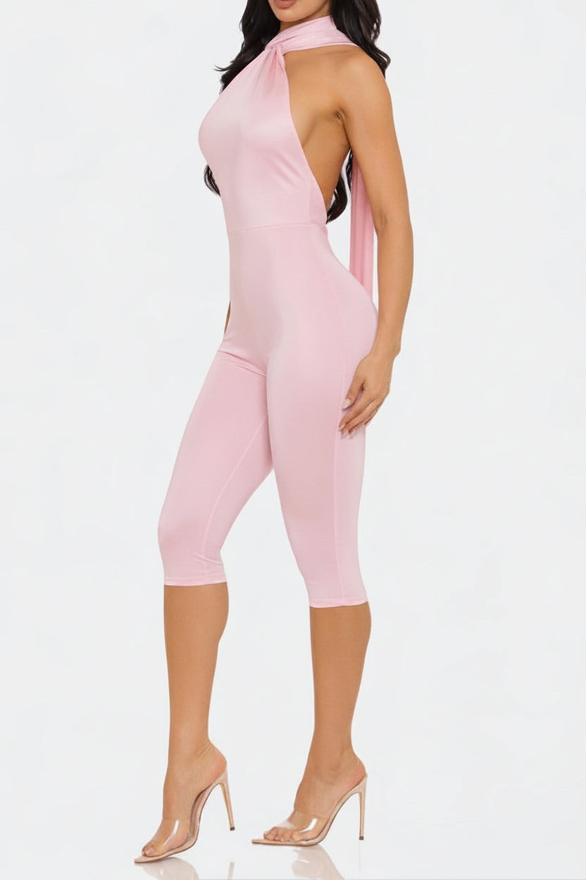 Pink jumpsuit worn by a model on a white background
