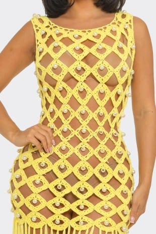 Yellow crochet dress with pearl embellishments on a white background