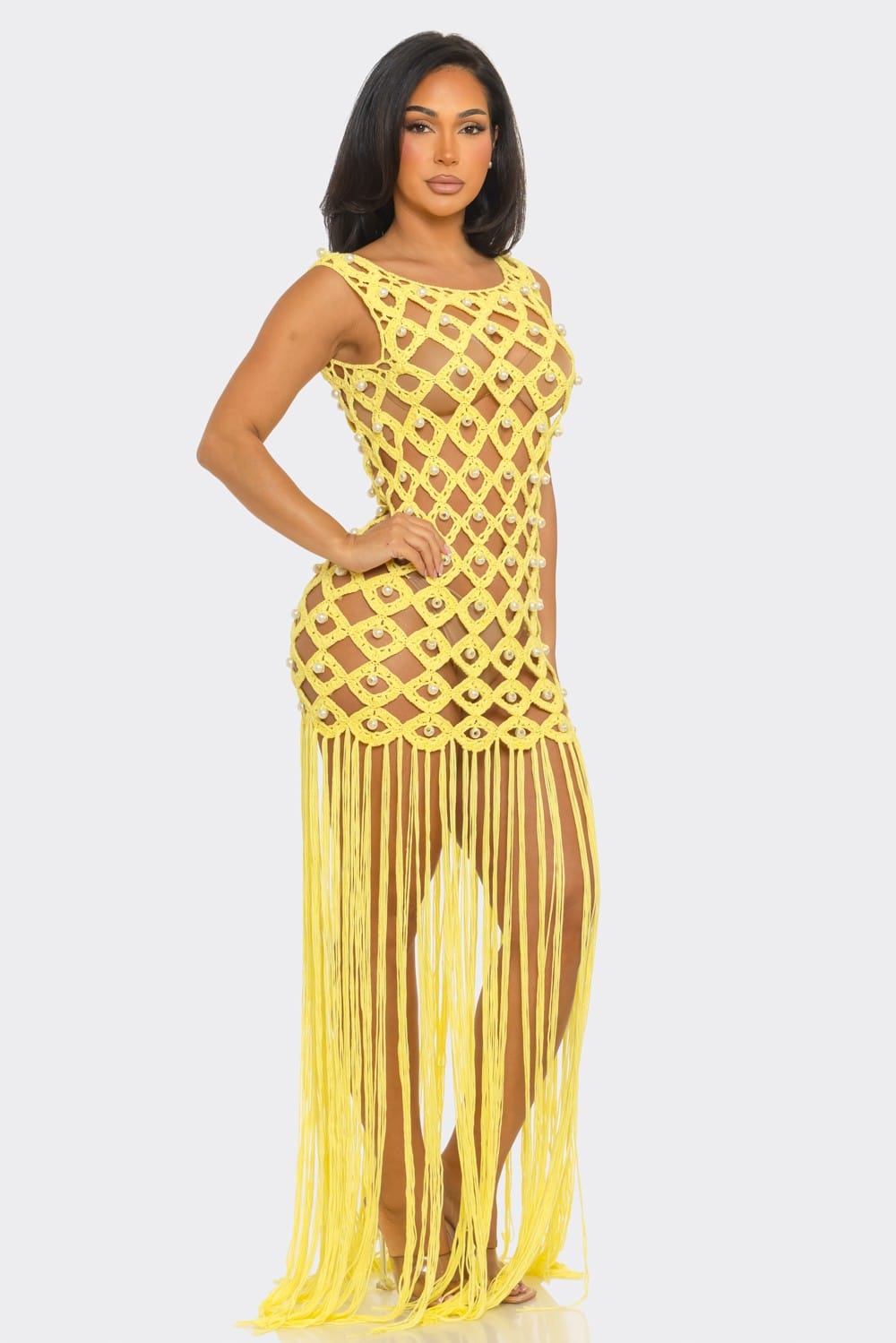 Woman wearing a yellow fringe dress on a white background