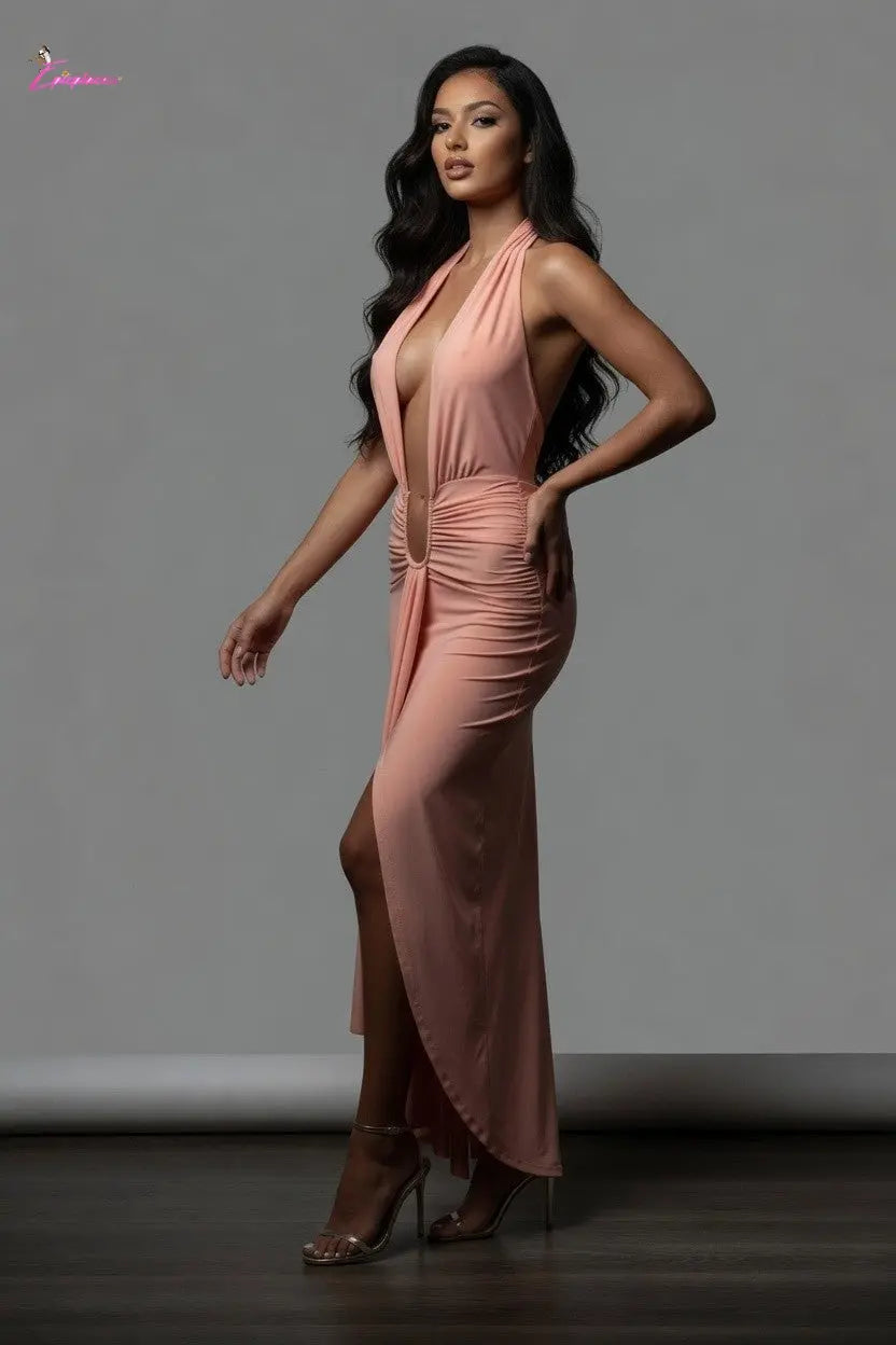 Woman wearing a pink dress with a gray background