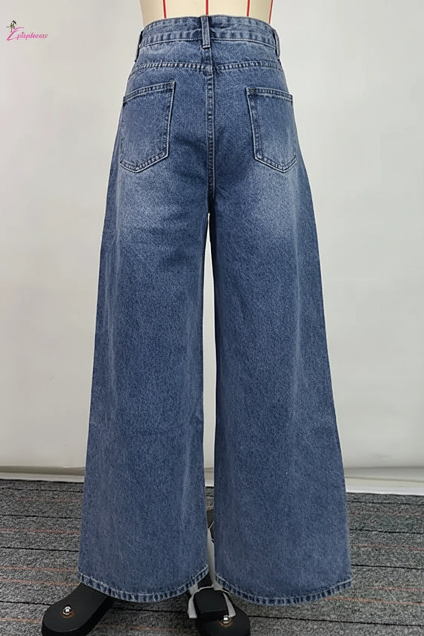 Wide-leg blue jeans on a plain background