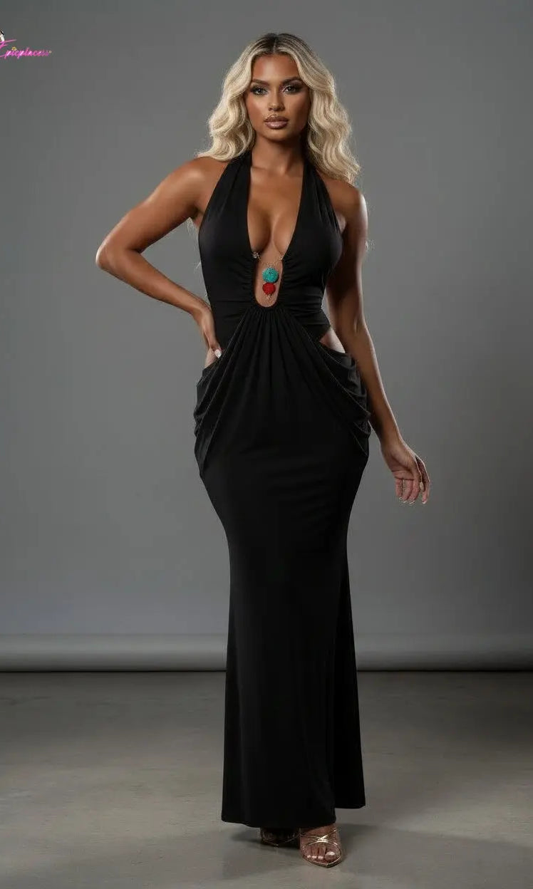 Woman wearing a black dress with cut-out design against a gray background