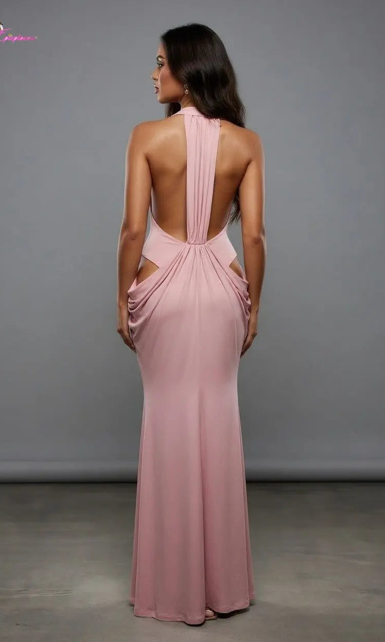 Woman wearing a pink evening gown with cut-out design against a gray background
