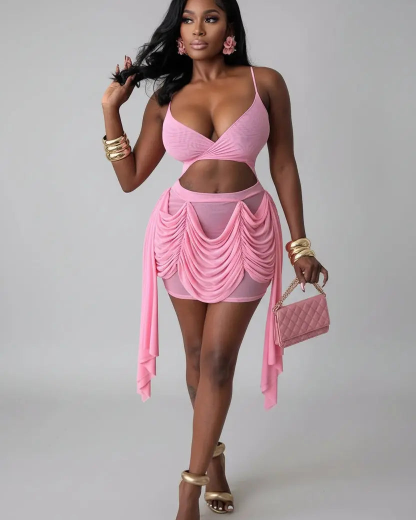 Woman in a pink outfit holding a matching handbag indoors.