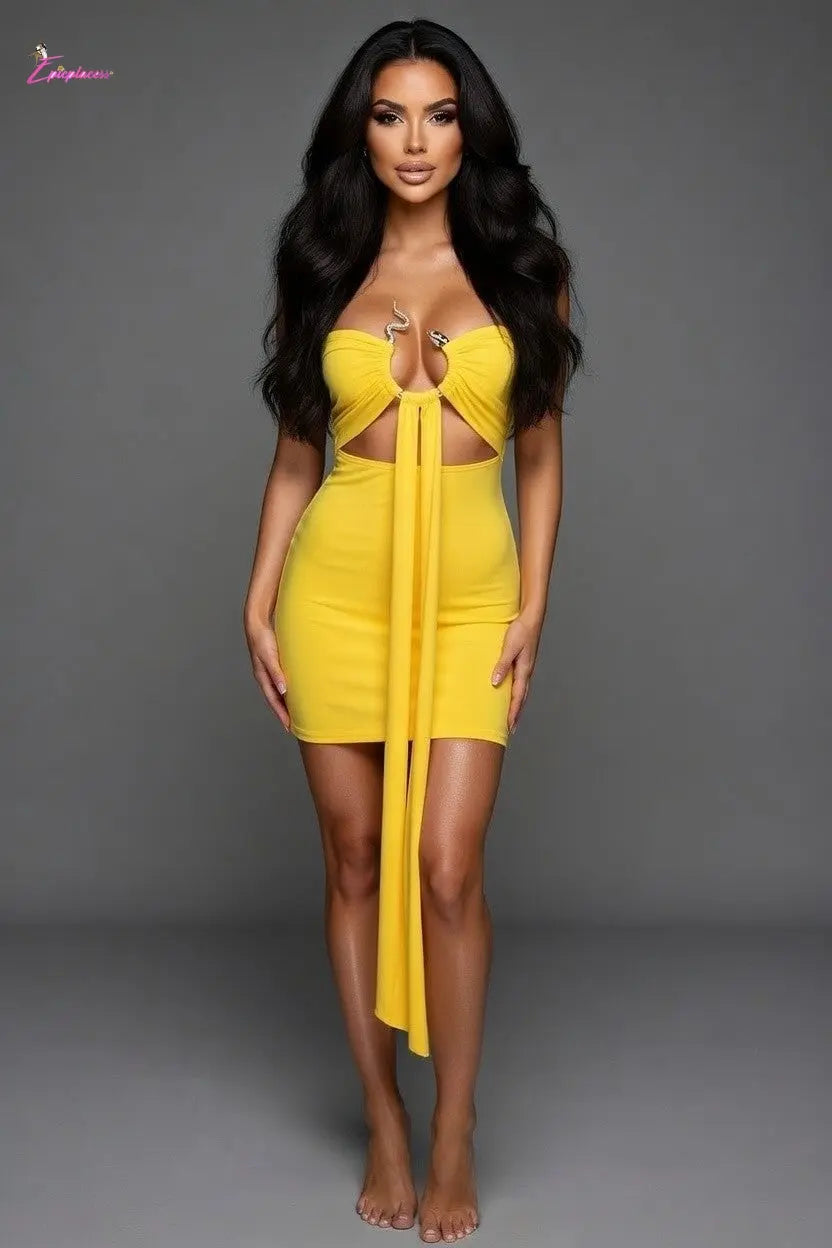 Woman wearing a yellow dress with cut-out design against a gray background
