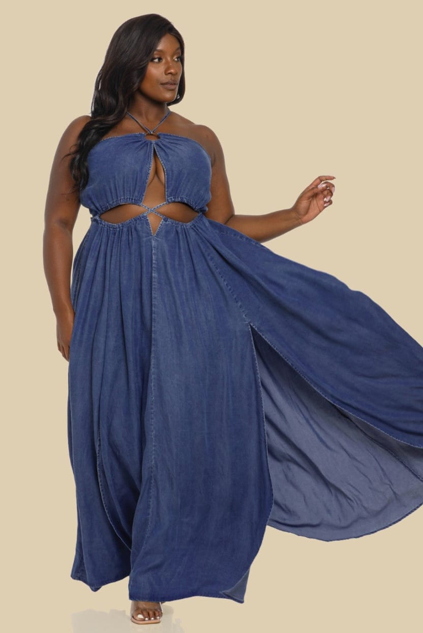 Woman wearing a blue dress with cut-out design on a beige background