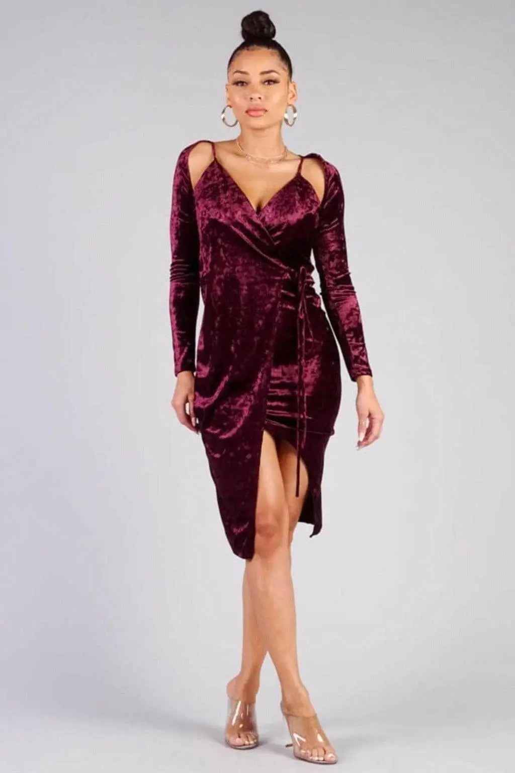 Woman wearing an elegant burgundy velvet wrap midi dress