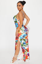 Woman wearing a colorful floral dress on a white background