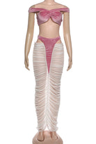 Mannequin wearing a pink off-shoulder top and beige ruched pants on a white background