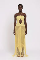 Yellow crochet dress with cut-out design on a white background