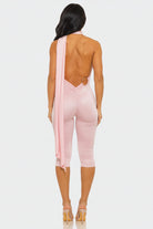 Pink jumpsuit with cut-out design on a white background