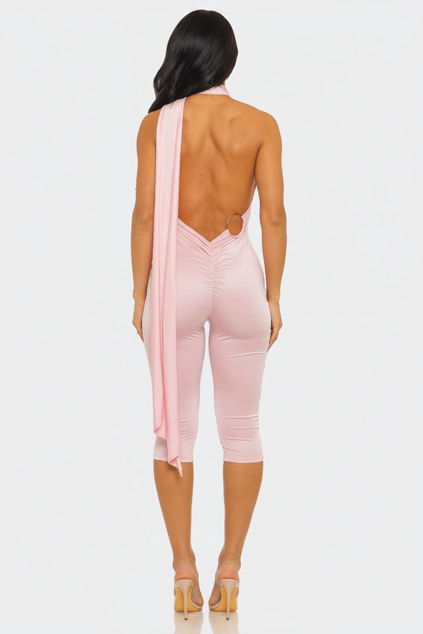 Pink jumpsuit with cut-out design on a white background