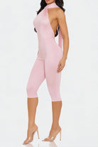 Pink jumpsuit worn by a model on a white background