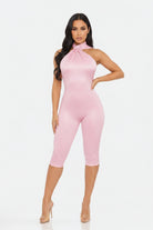 Pink halter neck jumpsuit on a white background
