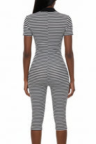 A black and white horizontally striped short-sleeve bodycon jumpsuit shown from the back on a white mannequin against a white background.