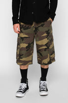 Camouflage cargo shorts worn by a person on a white background
