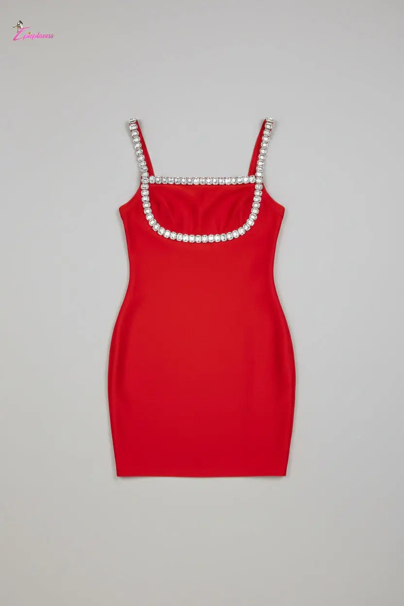 Red dress with embellished straps on a textured surface