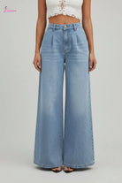 Person wearing light blue jeans on a city street.