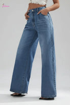 Person wearing blue wide-leg jeans on a city street.