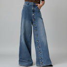 Wide-leg jeans with button details on a white background