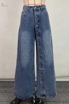 Wide-leg blue jeans on a mannequin against a plain background
