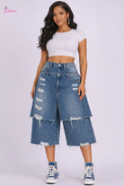Studio professional photo of high-waist distressed denim layered midi skirt with raw hem on white background