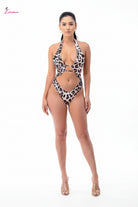 Woman wearing a leopard print swimsuit on a white background
