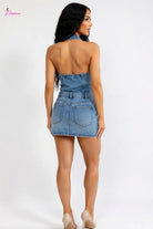 Woman wearing a denim dress on a white background