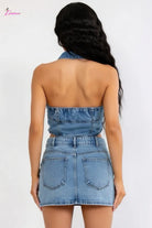 Woman wearing a denim strapless top and skirt set on a white background