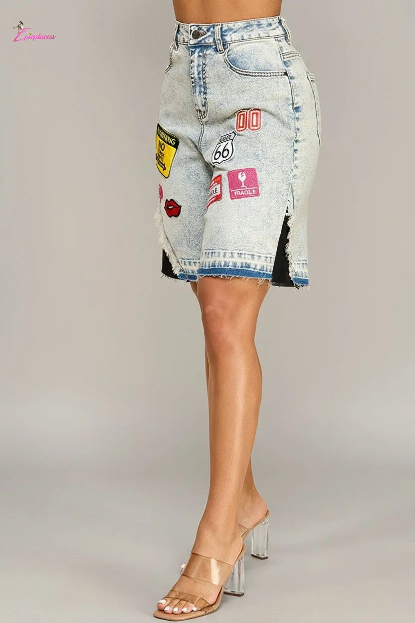 Denim shorts with patches on a beige background