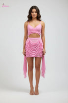Pink dress on a mannequin against a white background