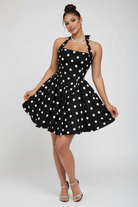Studio professional photo of black polka dot halter mini dress on white background