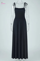 Black dress with bow straps on a mannequin against a white background
