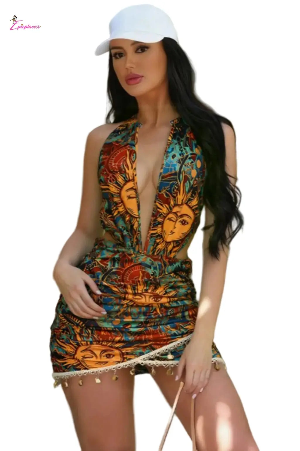 Woman wearing a colorful dress with sun designs outdoors